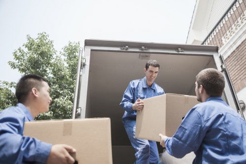 Professional movers loading boxes and household items