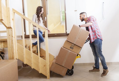 Professional movers loading items carefully in a London residential street